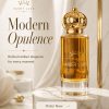 Amber Urbn by Scent Luxe perfume bottle with gold crown cap displayed on a marble podium against a soft ivory background